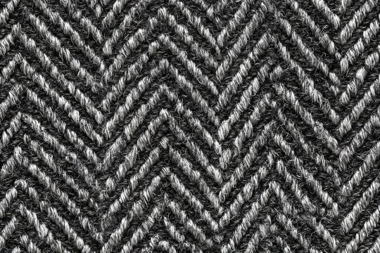 Seamless textured fabric background with gray herringbone weave, heavyweight wool-like material, visible slubs, charcoal and silver yarn variations, perfect for upholstery, wallpaper (1)