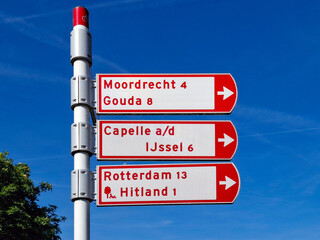 Red direction signs to Moordrecht, Gouda, Capelle, Rotterdam and Hitland for cyclists