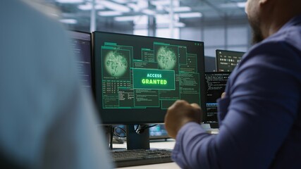 Happy data center employee pleased after successfully installing cybersecurity framework, seeing...