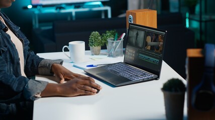Professional video editor analyzing film montage before editing color grading and lighting in...