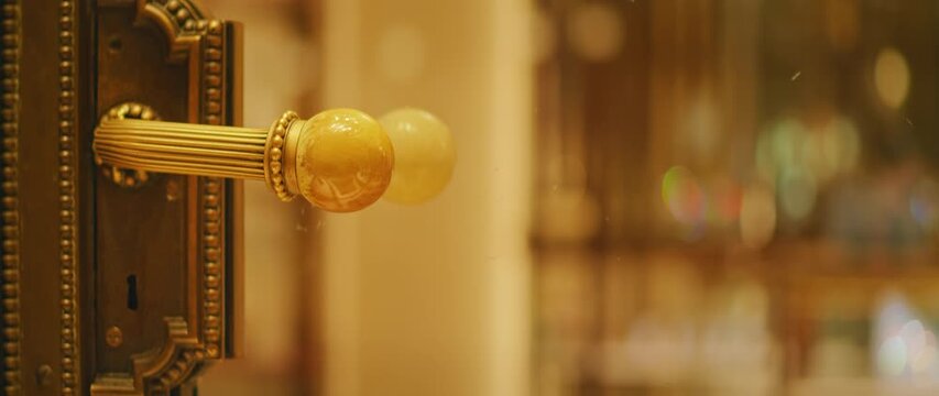 Closeup of ornate vintage doorknob and lock in luxurious interior setting background