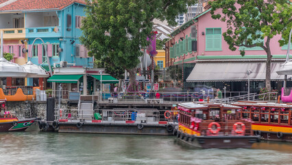 Tourist boats docking at Clarke Quay habour timelapse.
