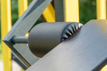 A close-up showcases a padded exercise bench with a sturdy frame and vibrant yellow accents. The bench promises comfort and support during intense strength training sessions © Роман Булатов