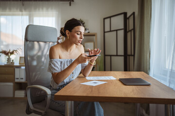 Adult woman have contactless payment scan invoice on cellphone at home
