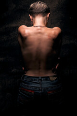 Fototapeta premium A woman with short, blonde hair stands with her back to the viewer