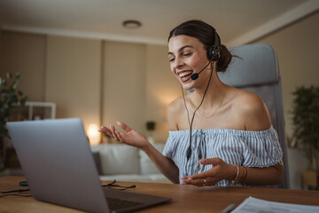 adult woman with headset have web conference while working from home