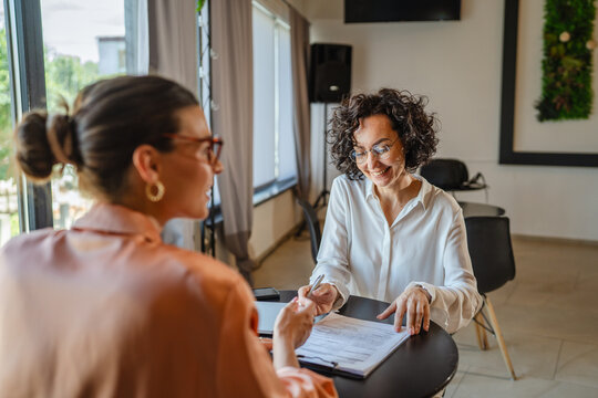 woman sign insurance or contract to financial adviser in the office