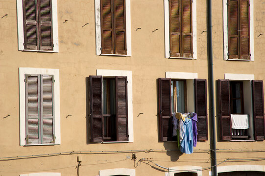 Window with clothes hanging out to dry in a house on the Bastioni seafront in Alghero, Sardinia, Italy