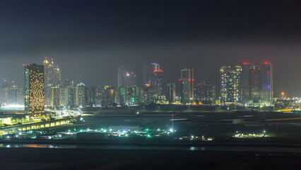 Buildings on Al Reem island in Abu Dhabi night timelapse from above.