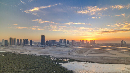 Buildings on Al Reem island in Abu Dhabi at sunset timelapse from above.