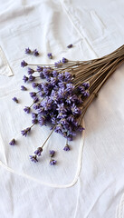 Dry lavender flowers on linen tablecloth, minimalism. White tone