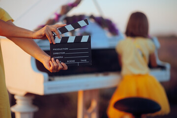 Movie Scene Where a Little Girl Plays the Piano in a Lavender Field. Crew filming a music video in...
