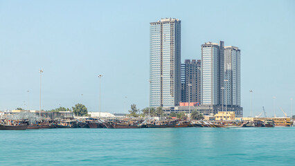 Fototapeta premium Traditional wooden fishing dhows berthed in the Dhow Harbour in Abu Dhabi timelapse
