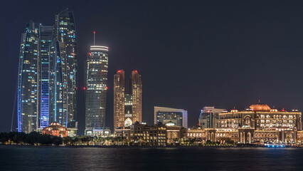 Obraz premium Skyscrapers of Abu Dhabi at night with Etihad Towers buildings timelapse.