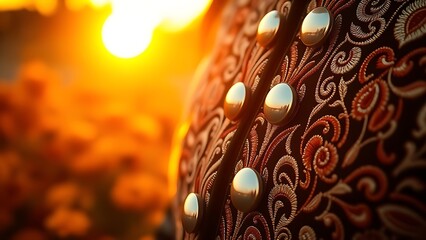 An embroidered charro jacket with silver buttons, bathed in golden sunset light, with marigold flowers softly blurred in the background.