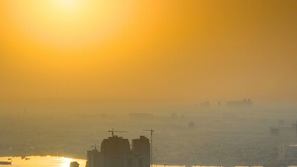 Obraz premium Sunrise with cityscape of Ajman from rooftop aerial timelapse.