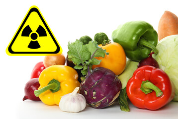 Fresh vegetables and radioactive sign on white background. Environmental contamination, polluted food