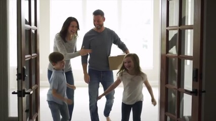 Happy family with children entering their new home for the first time. - Powered by Adobe