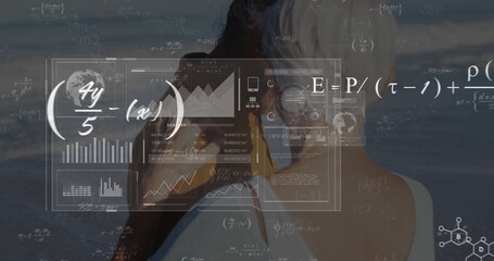 Viewing senior couple examining sea shore data overlay, with binoculars, charts and equations