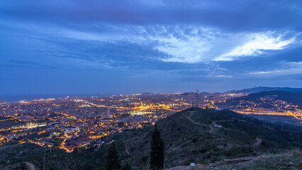 Fototapeta premium Barcelona and Badalona skyline with roofs of houses and sea on the horizon day to night timelapse
