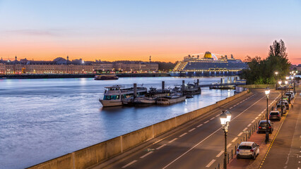 Ship and boats docked along the Garonne River day to night timelapse in Bordeaux, France
