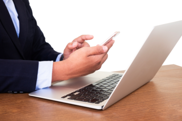 businessman using mobile phone and working on laptop