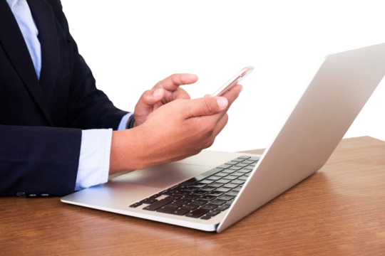 businessman using mobile phone and working on laptop