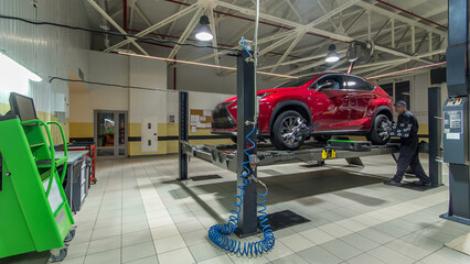 Car on stand with sensors on wheels for wheels alignment camber check in workshop of Service station timelapse.