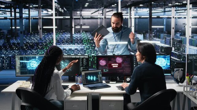 Data center manager coordinating programmers fixing critical error while using AI. Server room team leader overseeing workers repairing glitch popup while using artificial intelligence, camera A