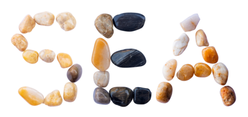 SEA word is made of stone with a white background. The creative shapes of the letters of the alphabet are arranged with stones.