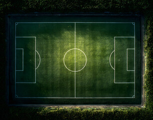 Aerial view of empty football field. Green grass texture with white lines marking pitch. Top down view of soccer field. Soccer game playground for sport. Competition field for match. Championship