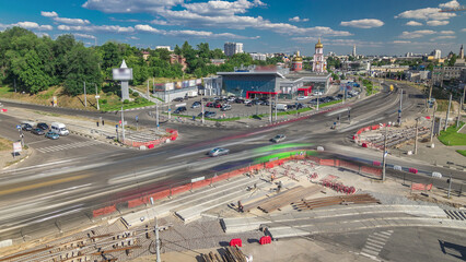 Aerial view of a large city intersection with road construction site urban works timelapse.
