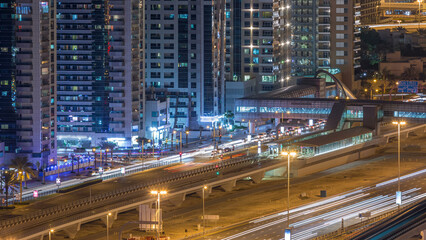 Fototapeta premium Aerial view of Dubai Tram in Dubai marina night timelapse.