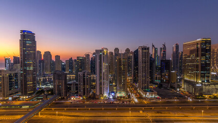 Fototapeta premium Dubai marina with traffic on sheikh zayed road panorama day to night timelapse lights turn on.