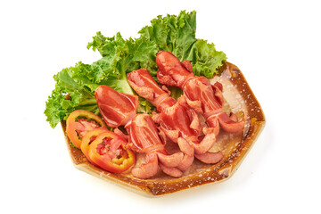 Crispy deep fried sausages served on ceramic plate with fresh lettuce and sliced tomatoes, creating vibrant and appetizing presentation