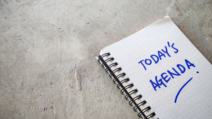 Today's Agenda Hand-Written in a Dot-Grid Notebook on a Cracked Concrete Background