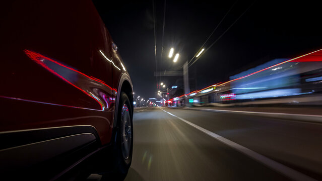 Drivelapse urban look from fast driving car at a night avenue in a city timelapse hyperlapse