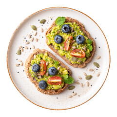 Top view of avocado toast with blueberries, tomatoes, sunflower seeds, pumpkin seeds and sesame...