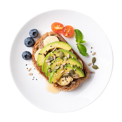 Top view of avocado toast with banana, sunflower seeds, pumpkin seeds, sesame seeds, blueberries,...