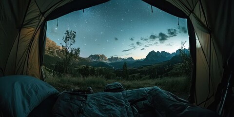 A camper's view from inside a tent, looking out at the starry night sky over a mountain range