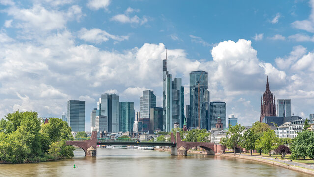 Hyperlapse of Frankfurt's skyscrapers skyline with the bell tower overlooking Alte Brucke. Frankfurt, Germany