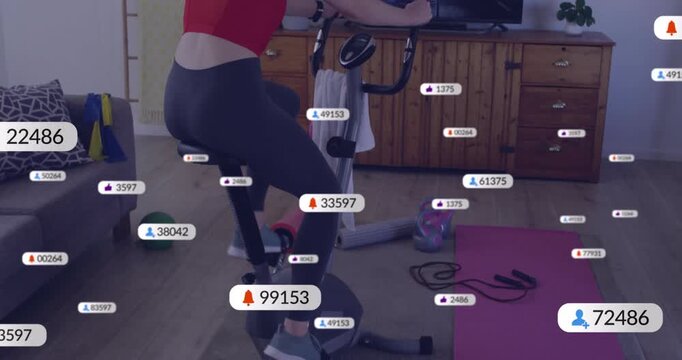 Woman entering gym and mounting bike, pedaling to boost live stats while matching onscreen cyclist