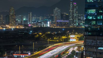 Top view of busy traffic night in finance urban timelapse, hong kong city