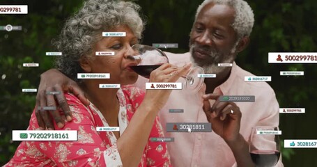 Senior couple sipping wine while notifications surrounding them showing social media engagement - Powered by Adobe