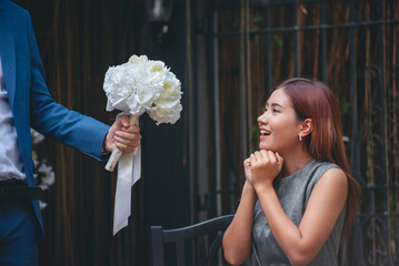 Surprise proposal young couple lover boyfriend give flower Bouquet to beautiful girlfriend to will...