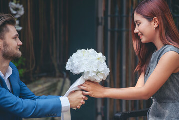 Surprise proposal young couple lover boyfriend give flower Bouquet to beautiful girlfriend to will...