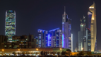 Skyline with Skyscrapers day to night timelapse in Kuwait City downtown illuminated at dusk. Kuwait City, Middle East