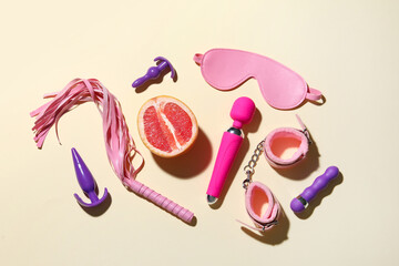 Sex toys with grapefruit on beige background
