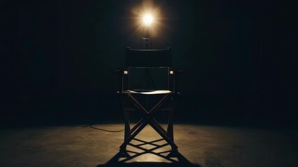 An illuminated director's chair positioned under stage lighting, suggesting a scene of dramatic intensity or character development in filmmaking or theatrical production.