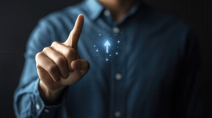 A male individual of unspecified ethnicity interacts with a futuristic interface, pointing upwards with a glowing arrow symbol, conveying technology and innovation in a dark setting.